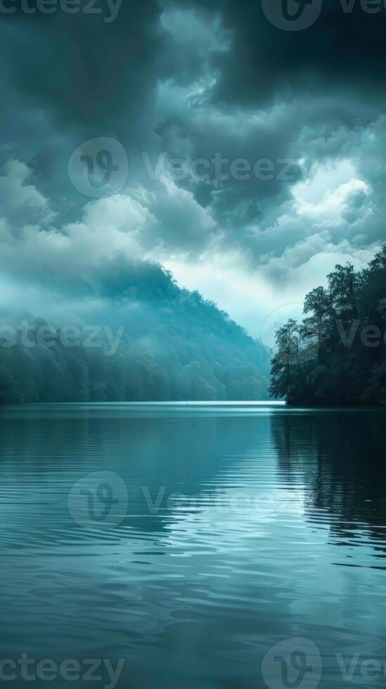 Calm lake waters reflecting a cloudy sky photo