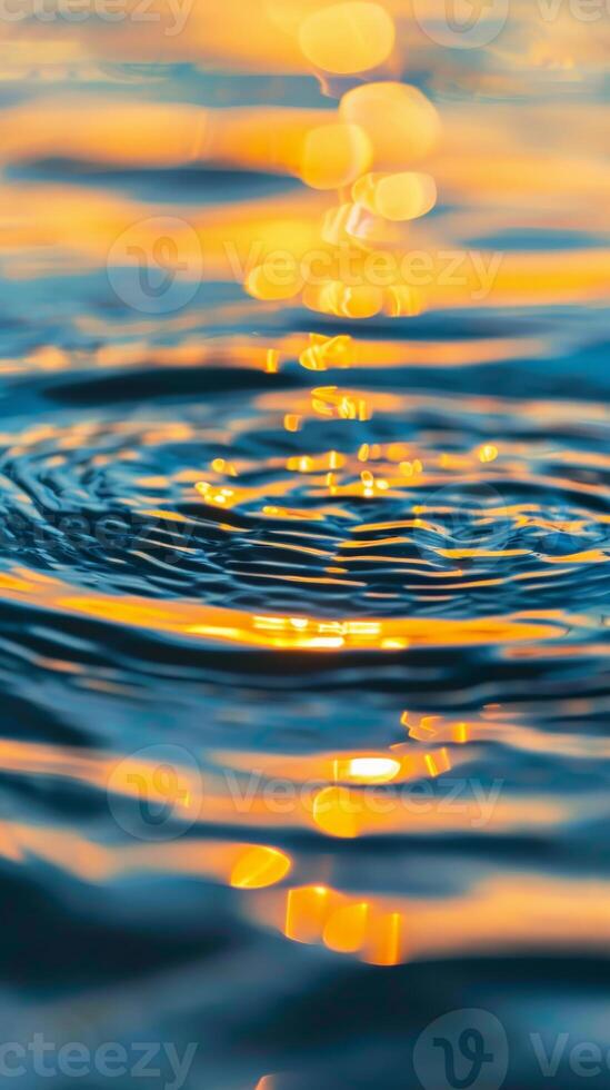 Water ripples and golden light reflect on the surface photo
