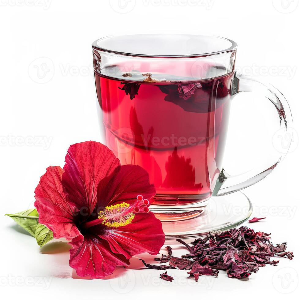 Red hibiscus flower next to glass of tea, petals scattered photo