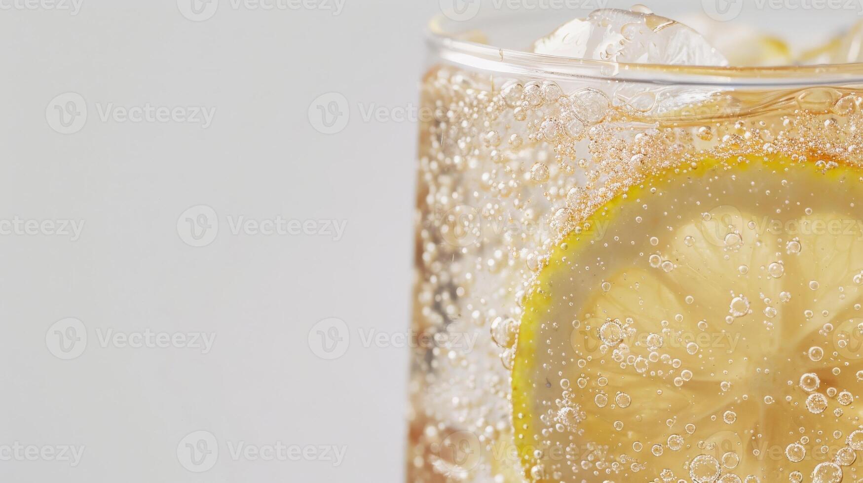 Close-up shot of a glass filled with lemon lime soda and ice, featuring a slice of lemon photo