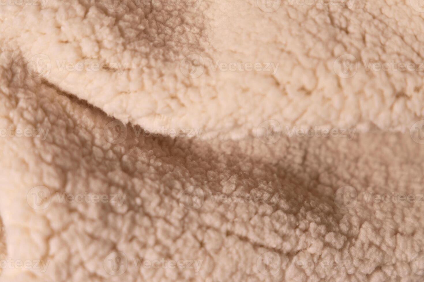 Top view of white soft sheepskin textile plaid. Warm cozy texture background photo