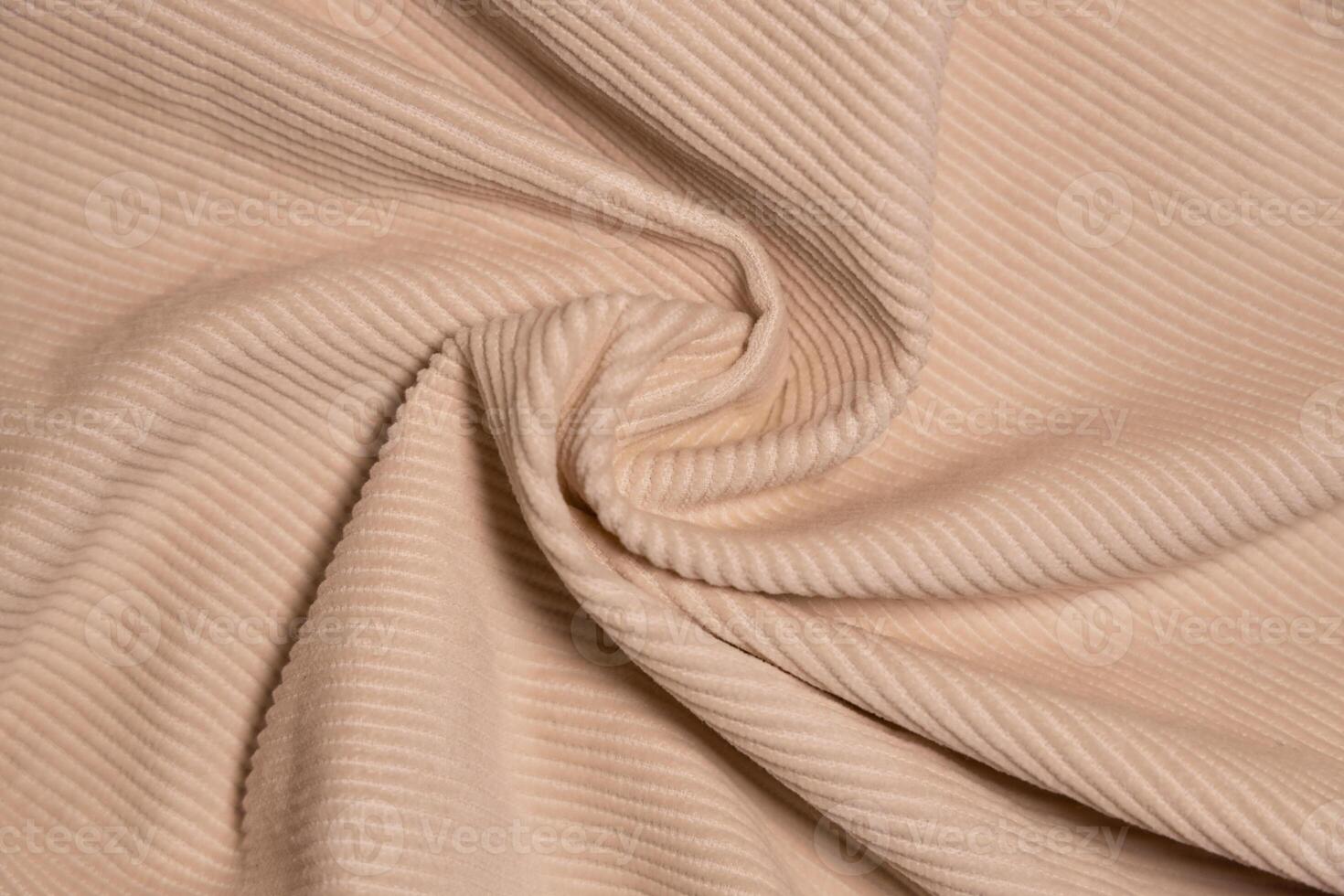 Velvety fabric texture pattern. Texture of velvet textile nude color. photo