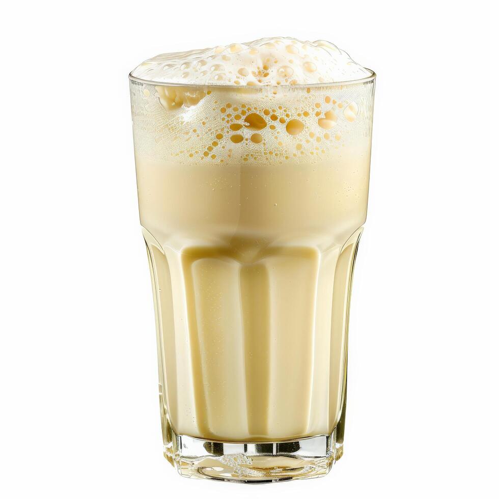 A glass of buttermilk with a thick layer of foam on top photo