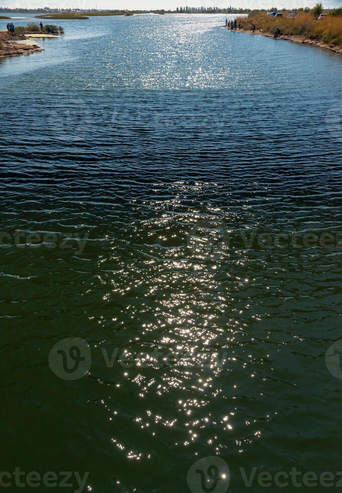 Reflection of the sun and glare in the water of the Tiligul estuary canal, Ukraine photo