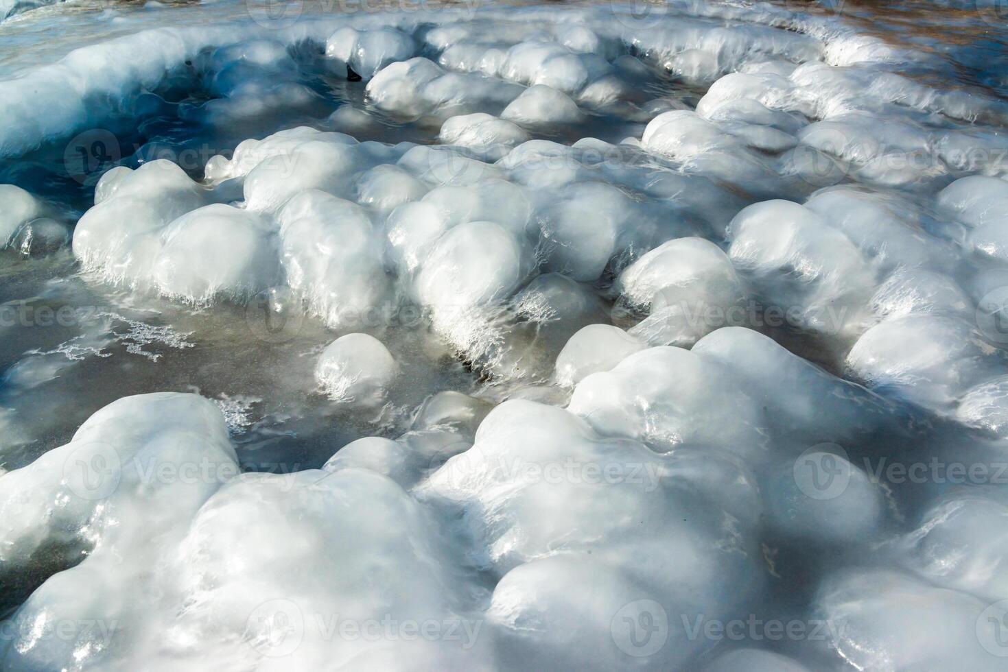 Smooth blocks of melting ice glisten in the sun, ice near the Black Sea, Odessa photo