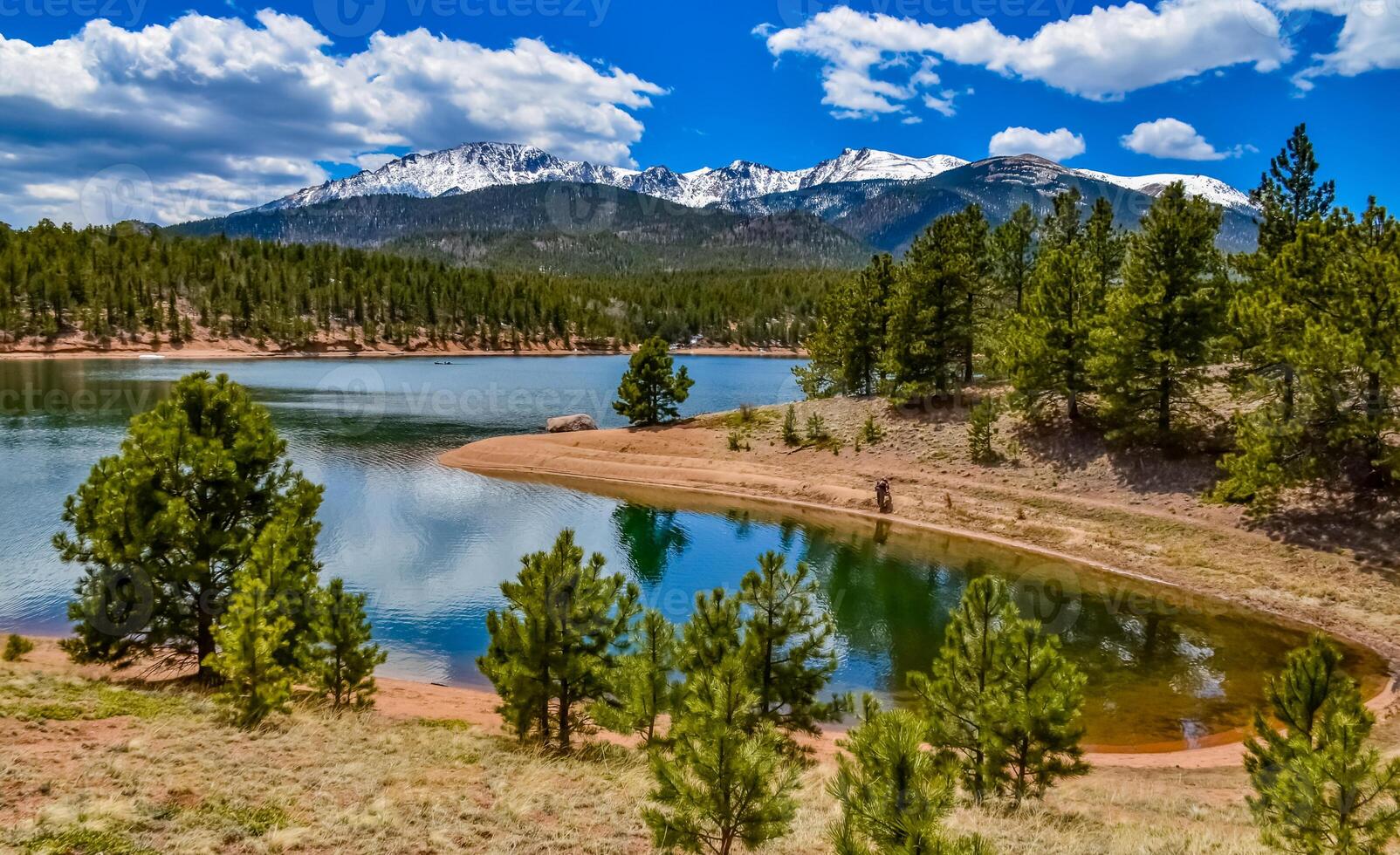 Panorama Snow-capped and forested mountains near a mountain lake, Pikes Peak Mountains in Colorado Spring, Colorado, US photo