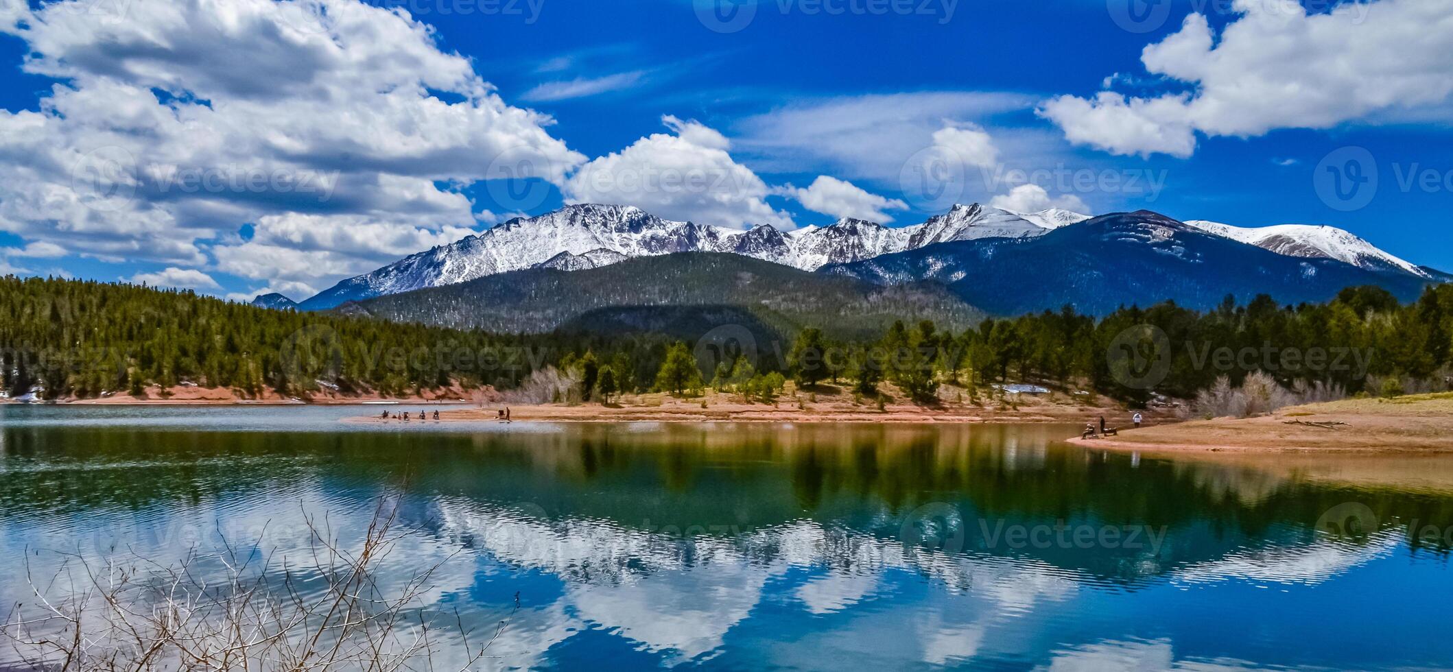 Panorama Snow-capped and forested mountains near a mountain lake, Pikes Peak Mountains in Colorado Spring, Colorado, US photo