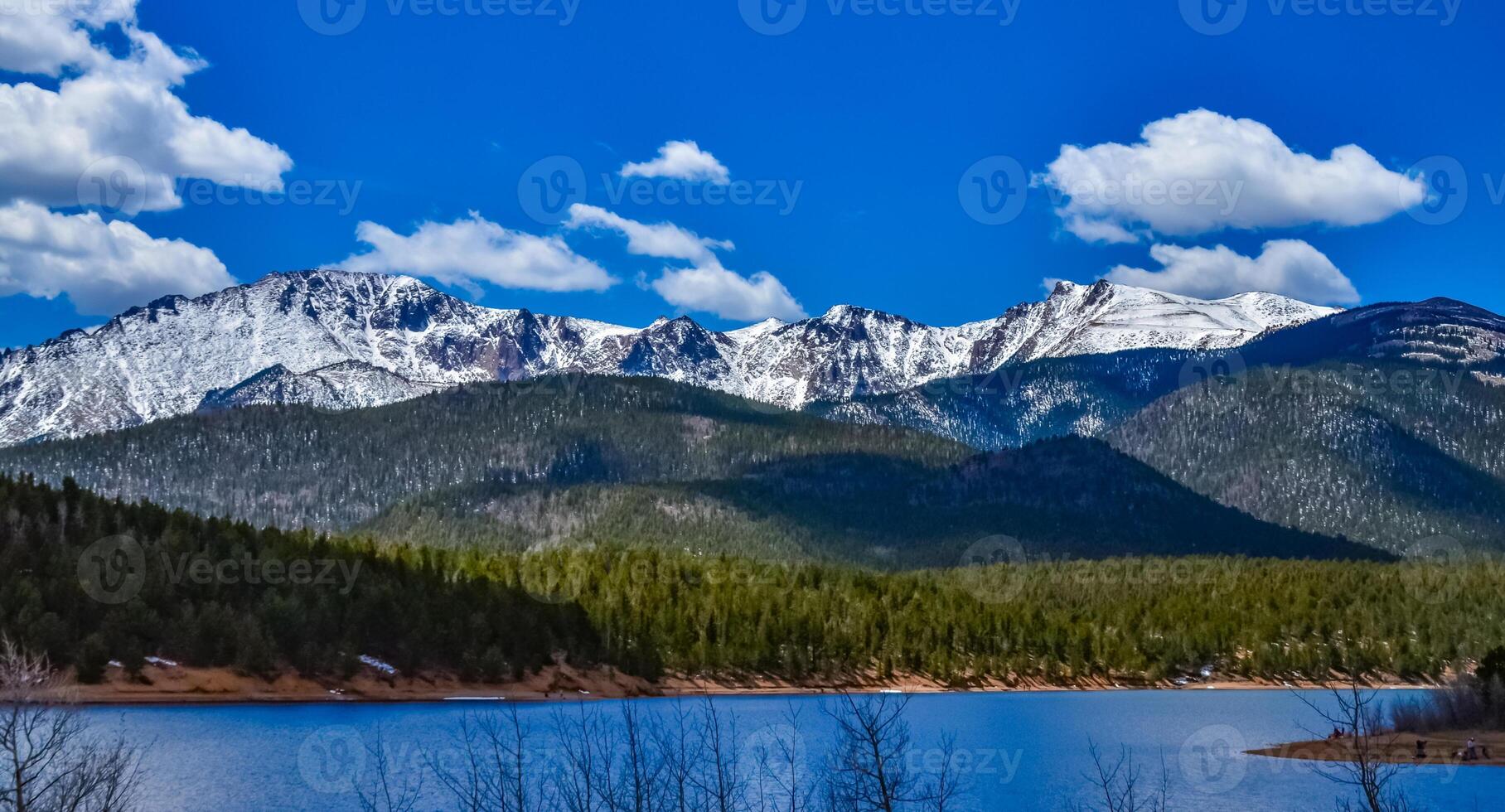 Panorama Snow-capped and forested mountains near a mountain lake, Pikes Peak Mountains in Colorado Spring, Colorado, US photo