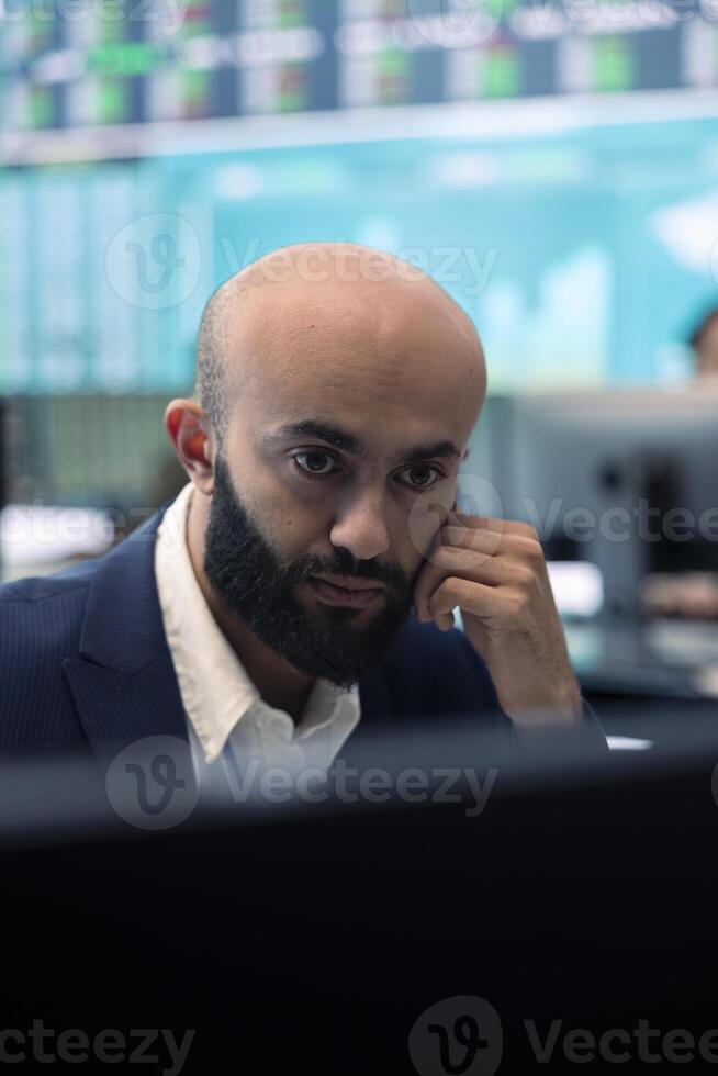 Enterprise manager analyzes annual reports and statistics on a pc, works on creating business strategies and goals. Analyst studying market dynamics and organizational progress. photo