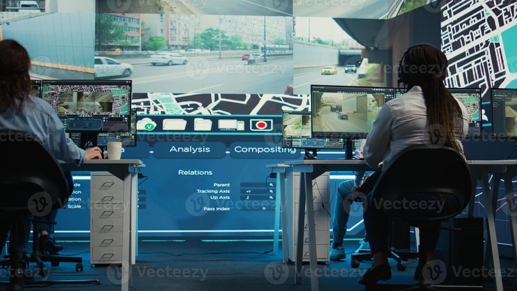 Diverse employees following the delivery track through city traffic, offering directions for less crowded street routes to ship cargo. Operators managing order tracking complains. Camera B. photo