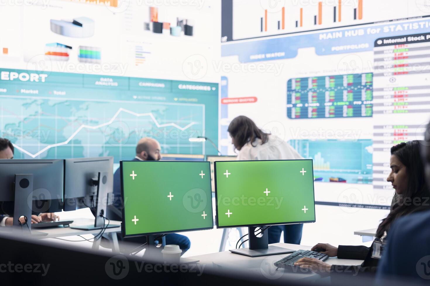 Executive officer analyzing green screen on monitors at his workstation, find ways of increasing organizational funds to expand the business globally. Isolated mockup screen in control room. photo