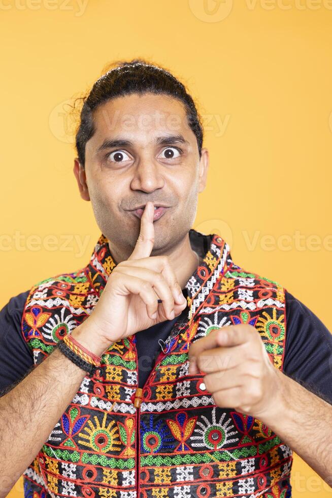 Authoritative man doing shushing hand gesturing, demanding secrecy, irritated by noise. Stern person complaining, placing finger on lips, doing quiet warning sign gesture, close up shot photo