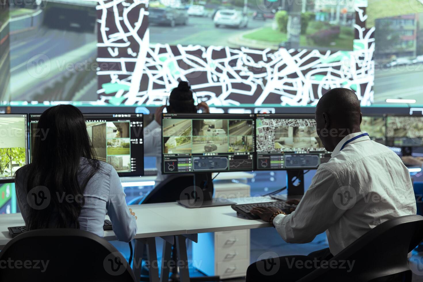 Team tracking a delivery car by using satellite navigation in agency control center, help couriers navigating around the city and avoid traffic to deliver orders in time. Surveillance CCTV footage. photo