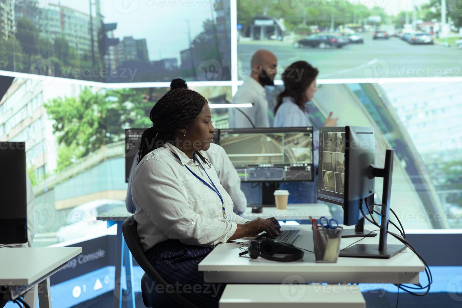African american government employee monitoring traffic to ensure public safety, reporting any illegal driving by registering the license plate numbers in the database. Using CCTV surveillance. photo