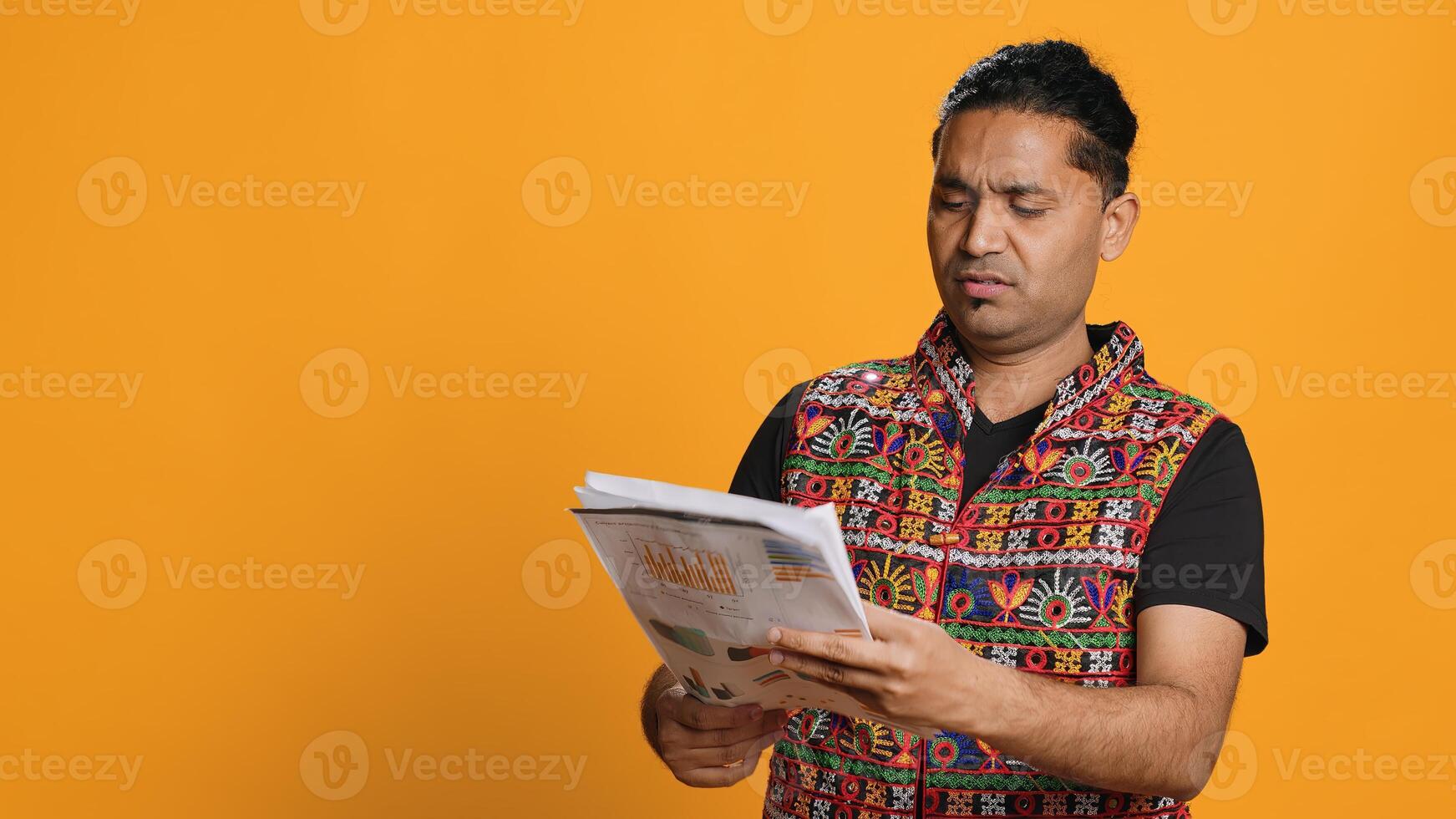 Irked manager browsing though financial audit report files, disappointed by work done by employees, studio background. Upset team leader throwing wrongly done paperwork in frustration, camera A photo