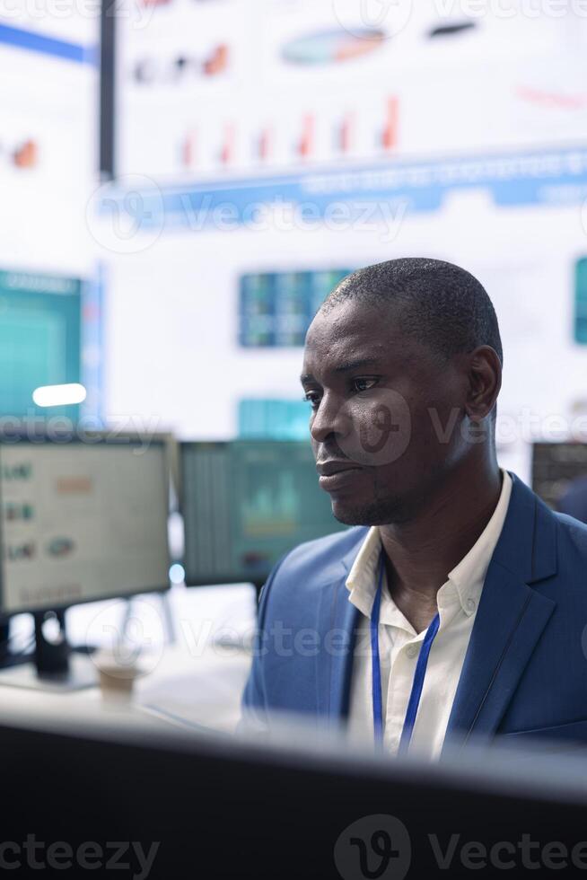 Company investor studying annual reports on a computer, gathering infographics to approve resources allocation for an expansion project. Analyst examines enterprise productivity. photo