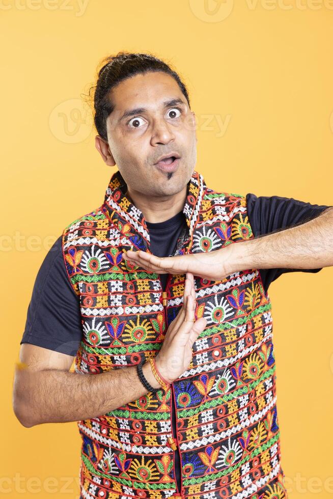 Angry man fed up with noise, requesting timeout, doing hand gestures. Zealous person doing insistent pause sign gesturing, wishing for break, isolated over studio background photo