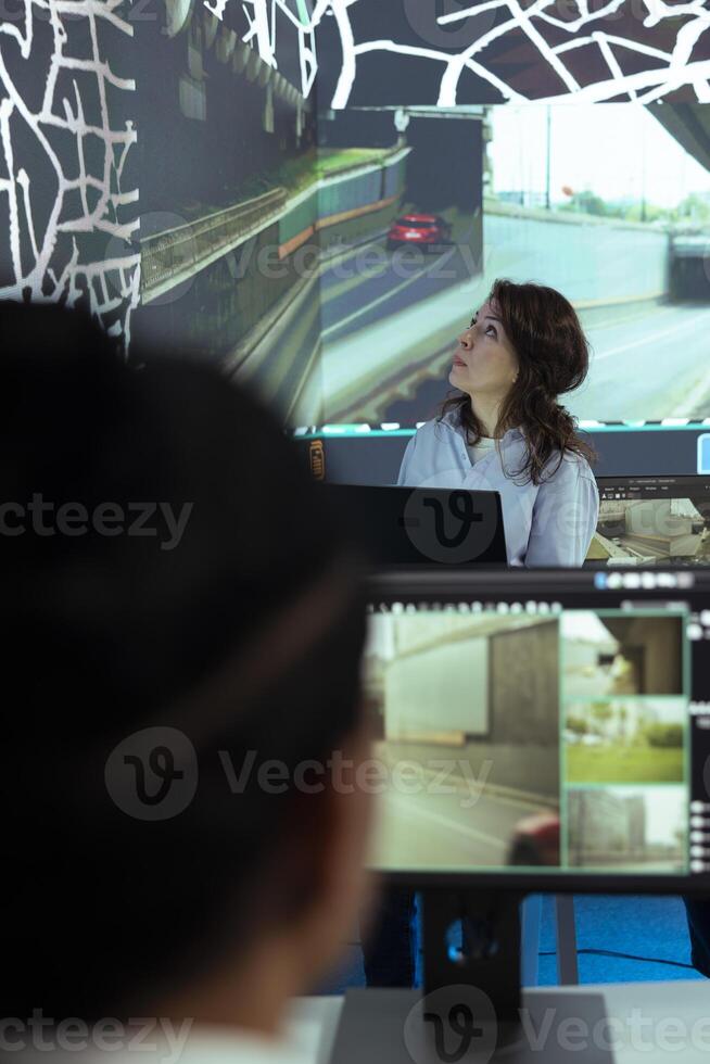 Team leader following the delivery truck through urban traffic, offering directions to the couriers for less crowded routes to ship parcels. Staff managing order tracking and transportation. photo