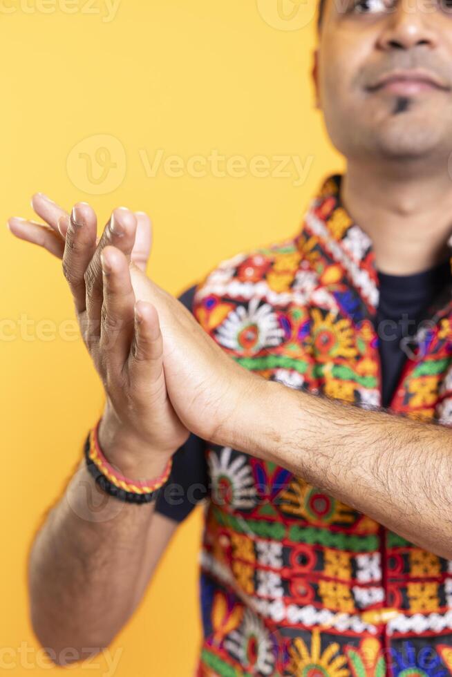 Close up shot of spectator clapping hands, praising entertainers, studio background. Person reacting to spectacle by applauding, doing standing ovation, isolated over studio backdrop photo