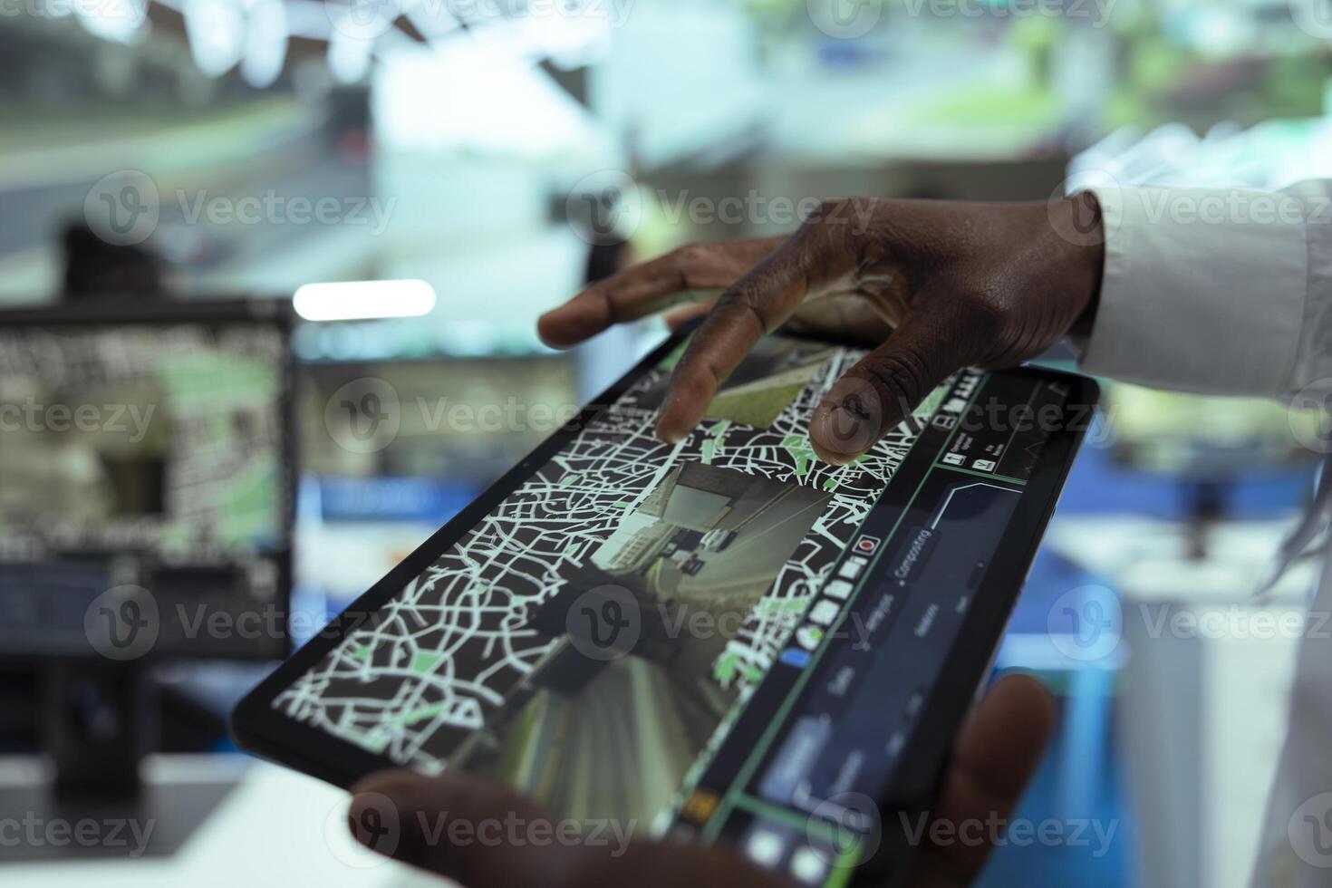 African american leader supervising delivery trucks on a tablet, monitoring shipment activity with a satellite map. Man finding gps coordinates to give directions to couriers in the field. Close up. photo