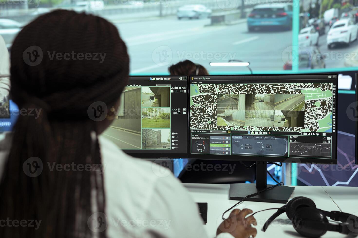 Agency employee following city traffic on her computer by using CTV footage, ensuring public safety. Woman monitoring surveillance system on satellite radar, control center. photo