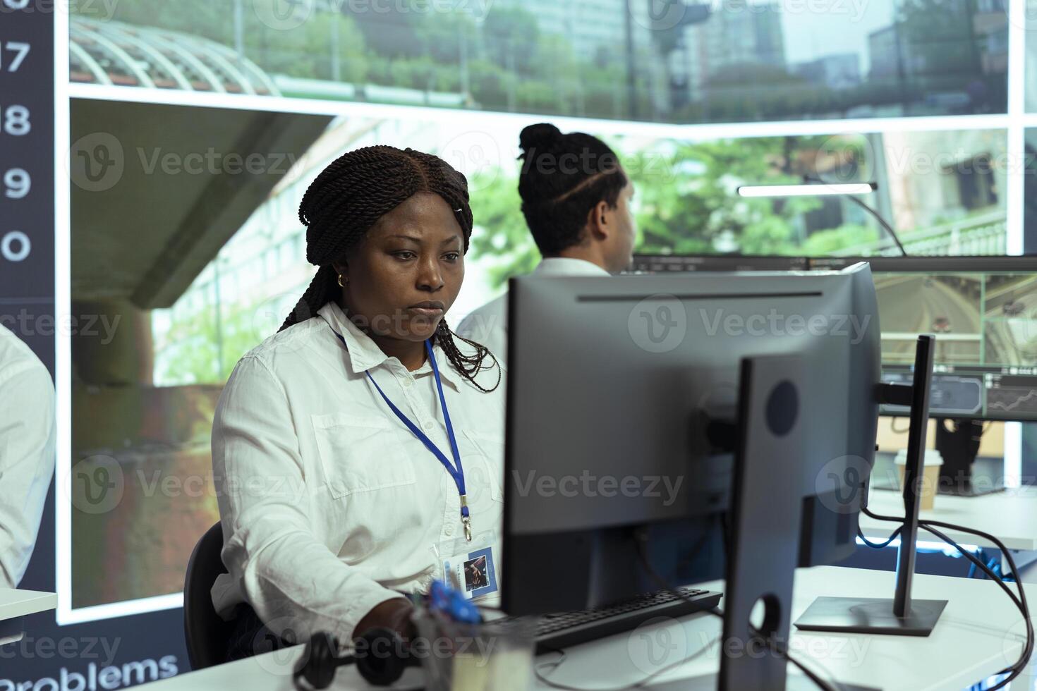 African american agency associate monitoring traffic activity to ensure public safety, registering license plate numbers in the government database. Real time CCTV surveillance footage. photo