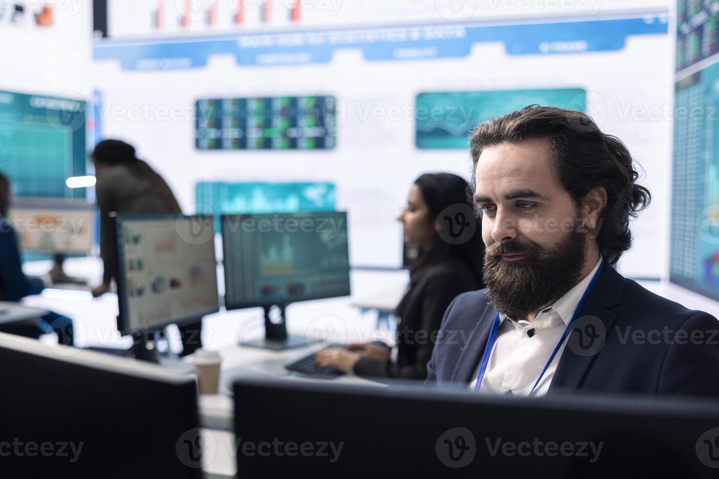 CEO reviewing business activity numbers on annual reports in control room, examining progress status and infographics. Finance advisor looks into big data analytics online at pc. photo