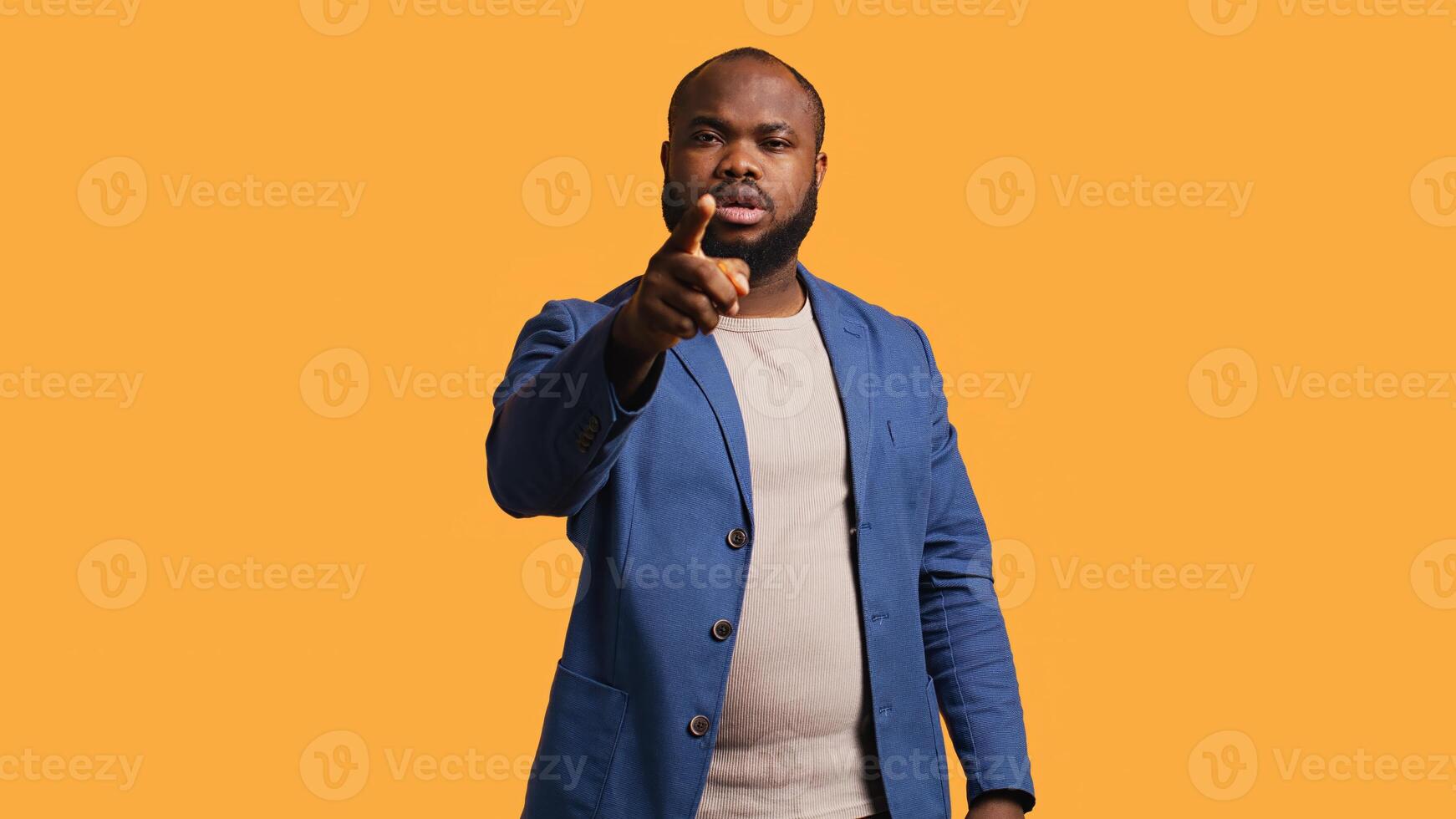 Angry african american man fighting with friend over debacle, isolated over studio background. Rude person in disagreement with mate, swearing and pointing finger, camera B photo