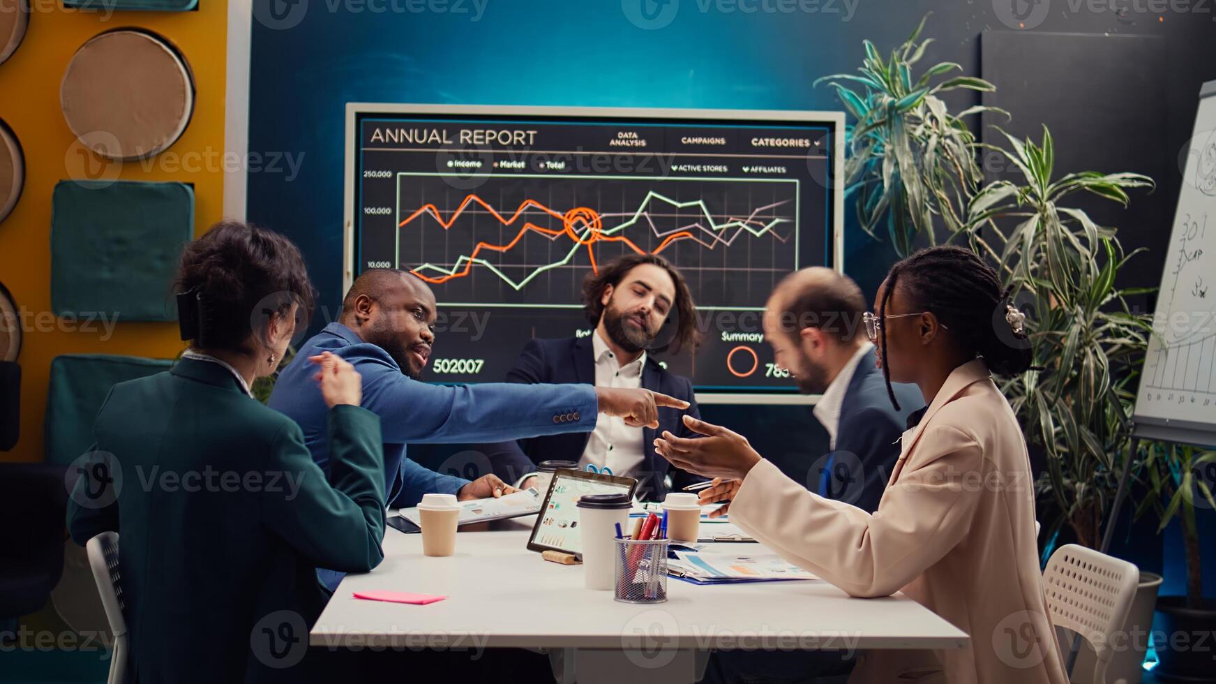 Public relations department working to improve the organization social media presence, attend an executive meeting. Studying trends and making decisions to corelate with company objectives. Camera B. photo