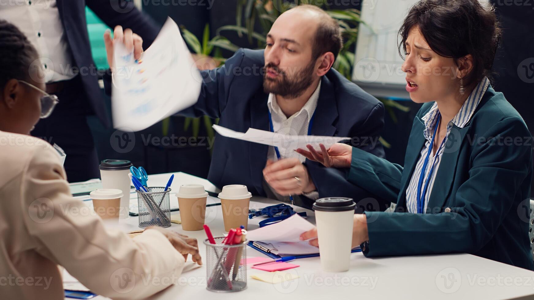 Frustrated business team working under pressure to meet project deadlines, being stressed to finish all important tasks and accomplish the organization goals. Strained corporation meeting. Camera A. photo