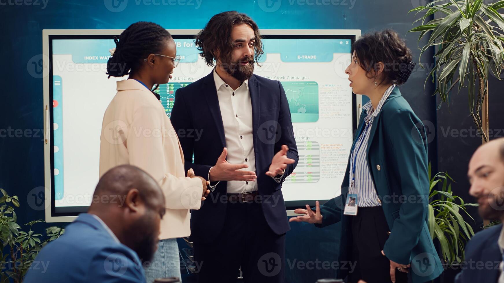 Team of startup colleagues preparing their presentation speech in front of the interactive board. Office employees meeting in a boardroom to review performance metrics as a group. Camera A. photo
