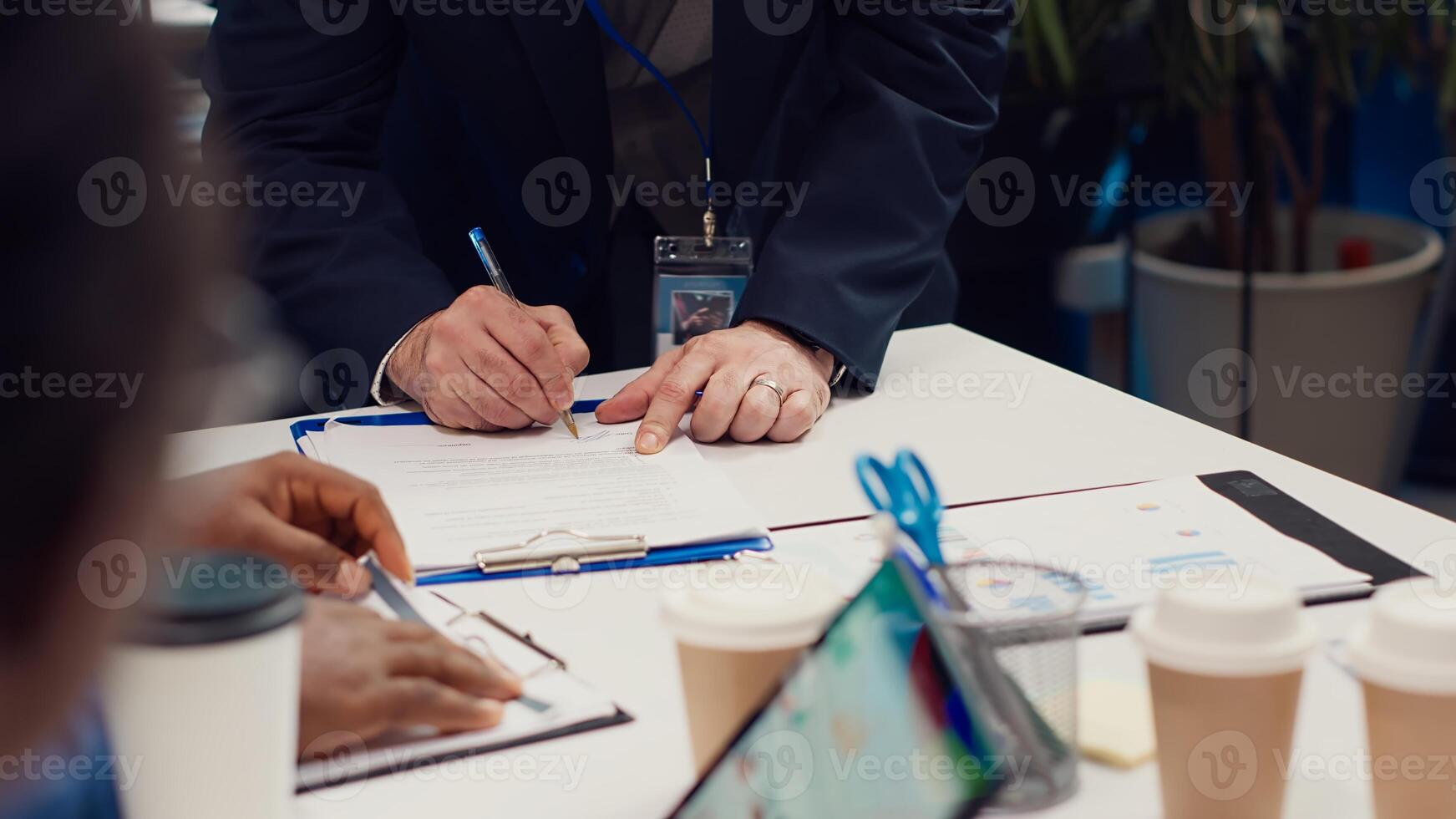 Entrepreneurs signing a new partnership contract between their firms, joining forces to capitalize on synergies. Managers collaborate to resolve specific skill gaps and development needs. Camera A. photo