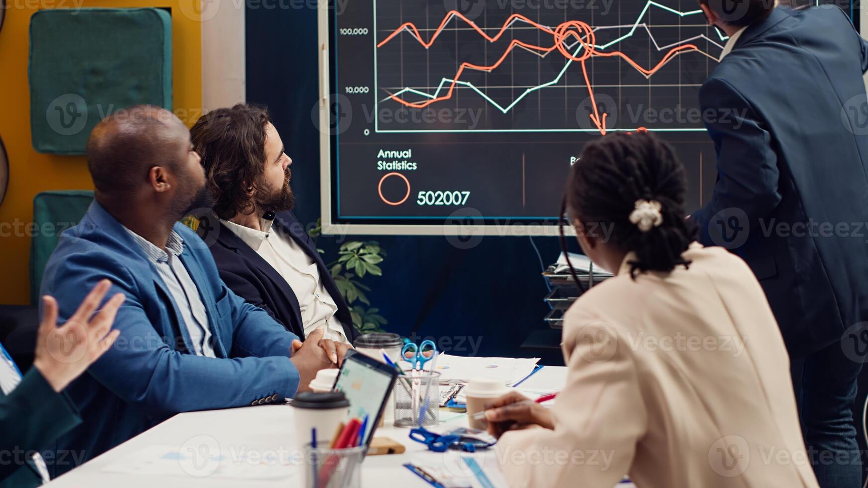Startup team evaluating infographics data in an executive meeting, corporate restructuring or organizational changes. Adapting the organization to evolving market conditions. Camera A. photo