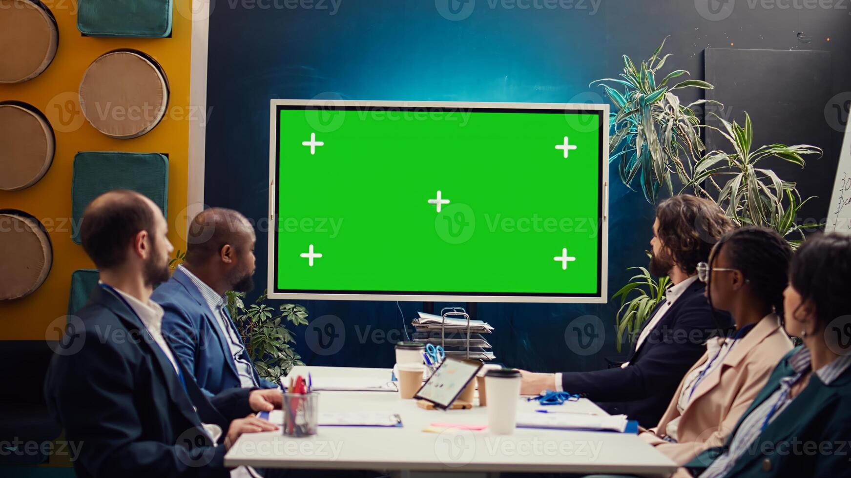 Startup team watching an ad campaign on greenscreen display, examining the final promotional product to ensure sales growth. PR specialists collaborating on enterprise development. Camera B. photo