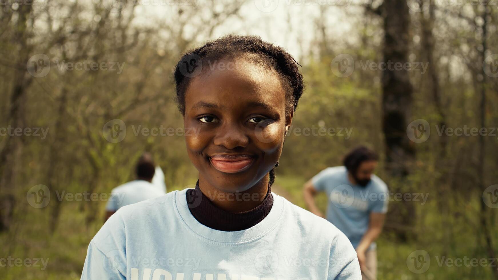 African american girl presenting small sprout with organic soil ready for planting in the ground, preserving nature and forest habitat. Young activist doing voluntary work to grow trees. Camera B. photo