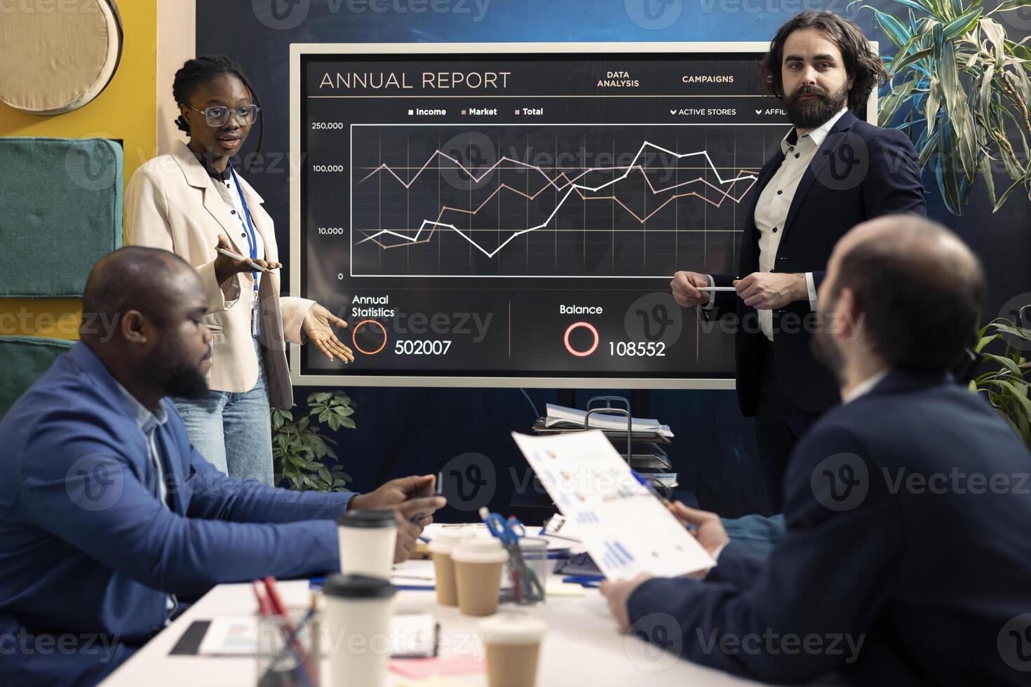 PR and marketing specialists following customer and market trends in an informative meeting, evaluating infographics together on interactive board. Business associates discussing enterprise growth. photo