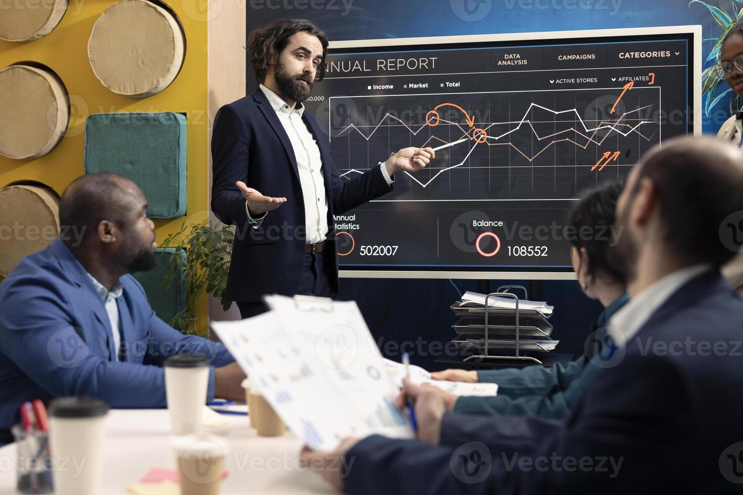 Chief operating officer presenting project goals and resource allocation during a meeting, creating successful pitch to present his ideas. Review performance indicators and marketing strategies. photo