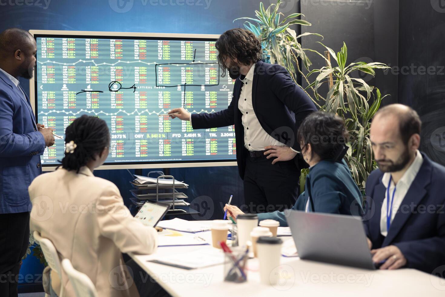 Corporate employees meeting in a conference room to discuss project updates, gathering important information from reports and planning steps to coordinate with business goals. Employee engagement. photo