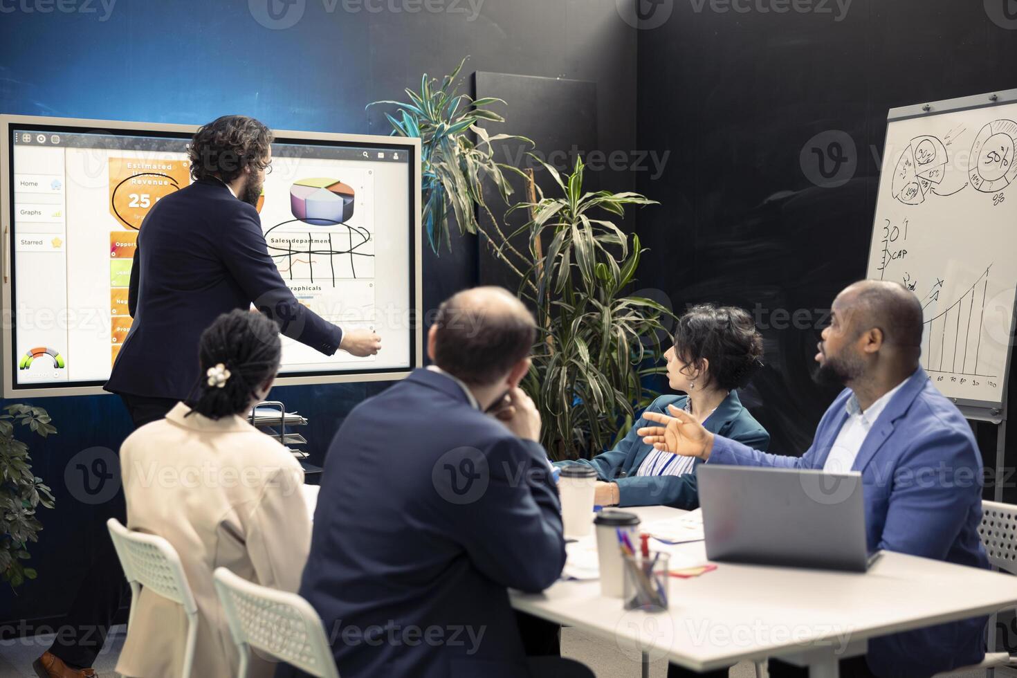 Team of business employees examining statistics and infographics on interactive board, joining forces together to gather insight for development. Coworkers discussing legal changes. photo