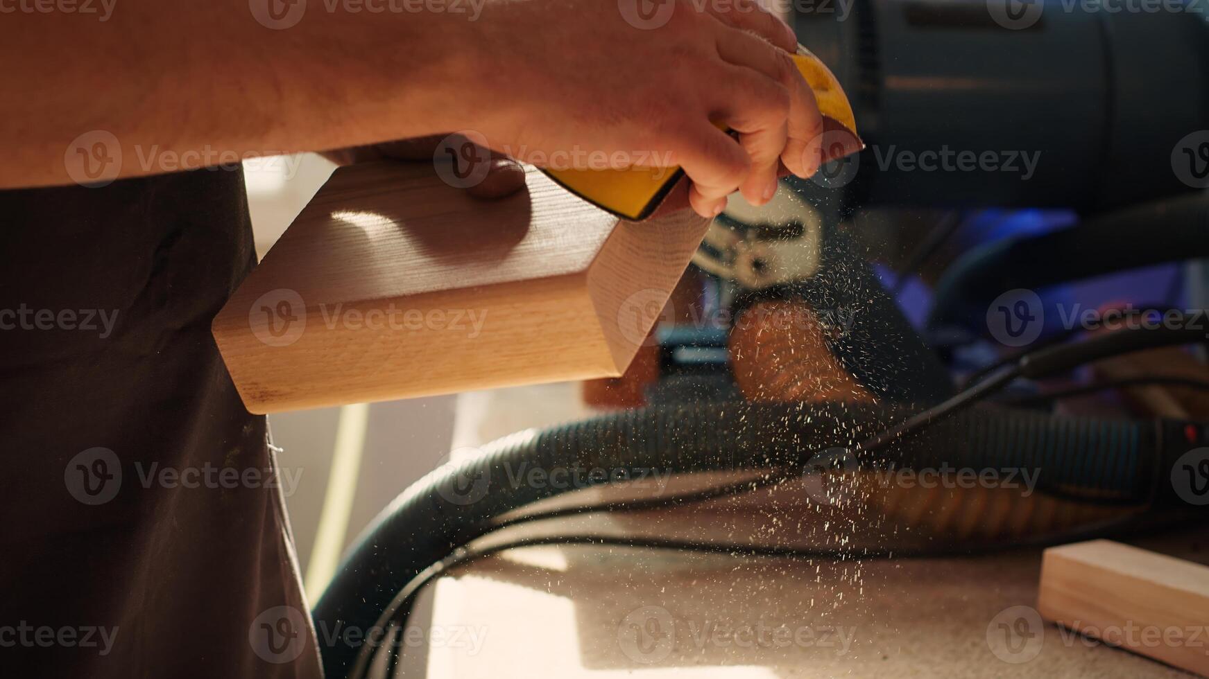Manufacturer working in joinery using sanding block to remove imperfections on wood piece. Woodworking specialist using coarse grade sandpaper to do manual sanding on lumber, camera A close up photo