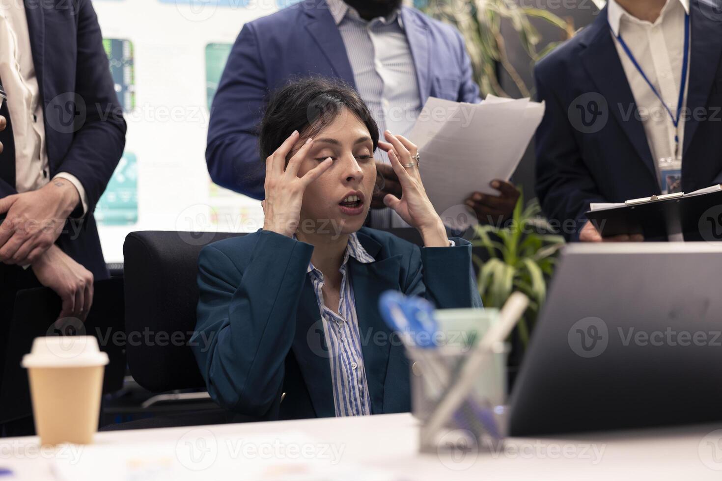 Frustrated irritated general manager being furious and judging her team, reviewing their work progress. Angry dissatisfied supervisor being displeased with the organizational workflow. photo