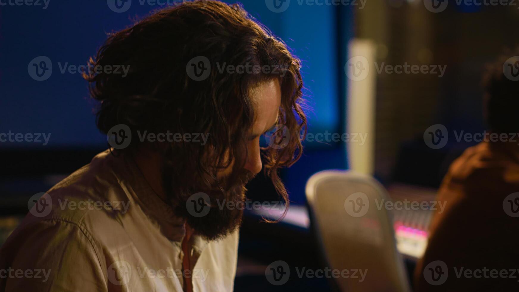 Singer performer creating a song on piano midi controller in studio, recording notes on electronic keyboard. Artist musician composing and producing tracks with technician. Camera A. photo
