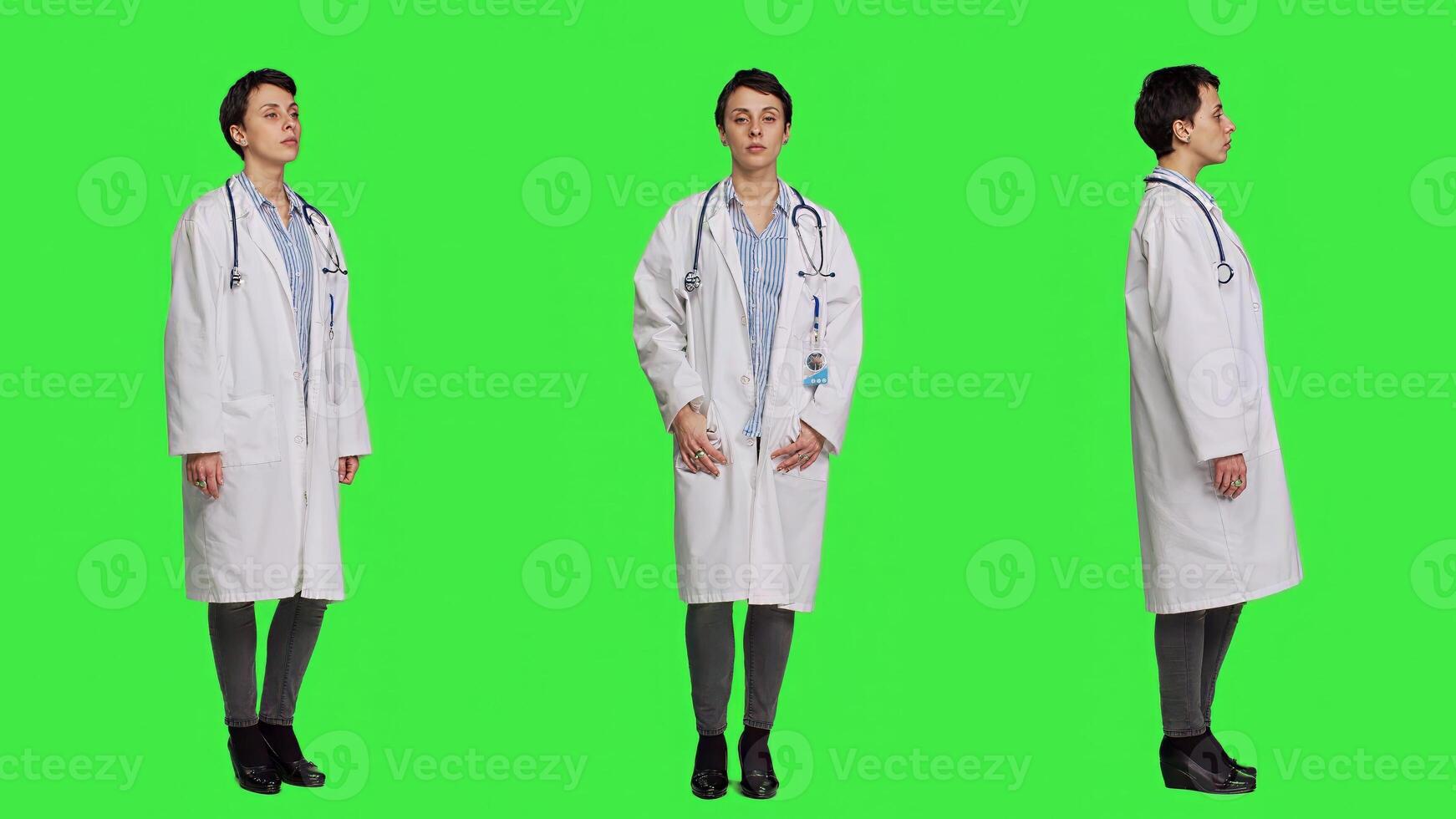 Portrait of health specialist wearing a white hospital coat in studio, standing against greenscreen backdrop. Successful doctor posing with confidence, medical industry expertise. Camera A. photo