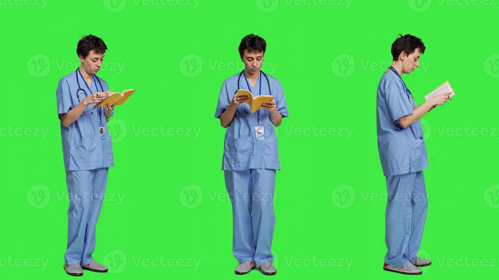 Medical assistant reading a literature book against greenscreen backdrop, enjoying healthcare industry lecture to acquire new expertise. Nurse paying attention to medicine manual at work. Camera A. photo