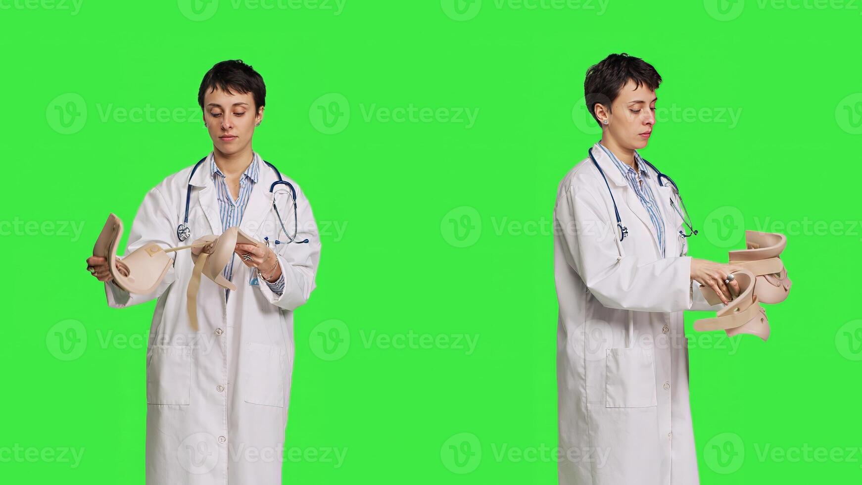 Orthopedics specialist holding a cervical neck collar against greenscreen backdrop, medical foam tool helping with fractures and physical therapy. Medic uses brace for accident trauma. Camera B. photo