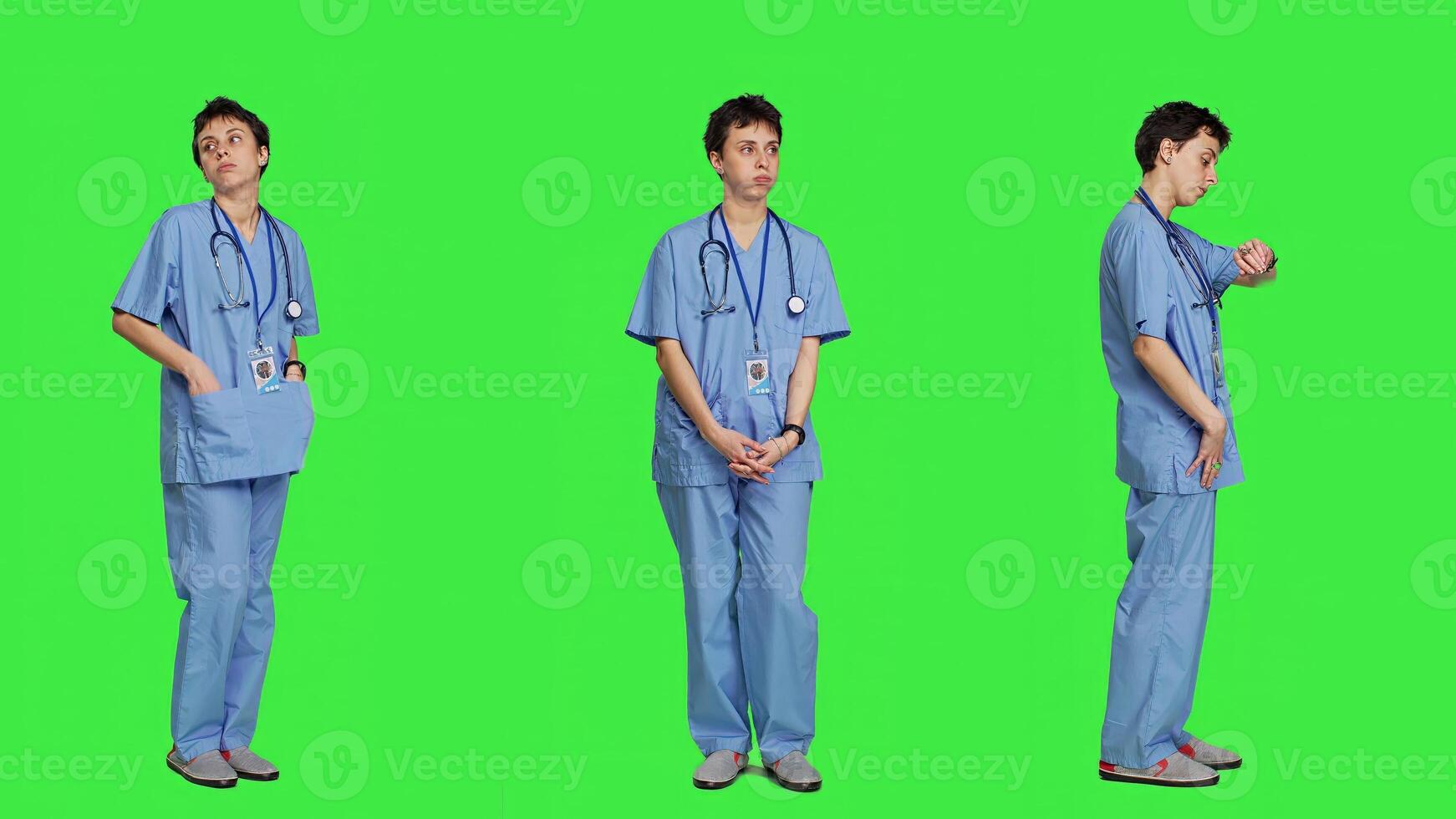 Stressed nurse checking time on watch and waiting for patient to arrive at checkup examination, being impatient against greenscreen backdrop. Medical assistant with scrubs and stethoscope. Camera A. photo