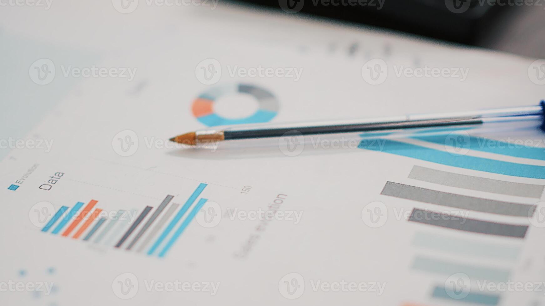 Business paperwork on office desk next to cup of coffee, extreme close up shot. Company documents containing charts and hot beverage on table in financial department workspace photo