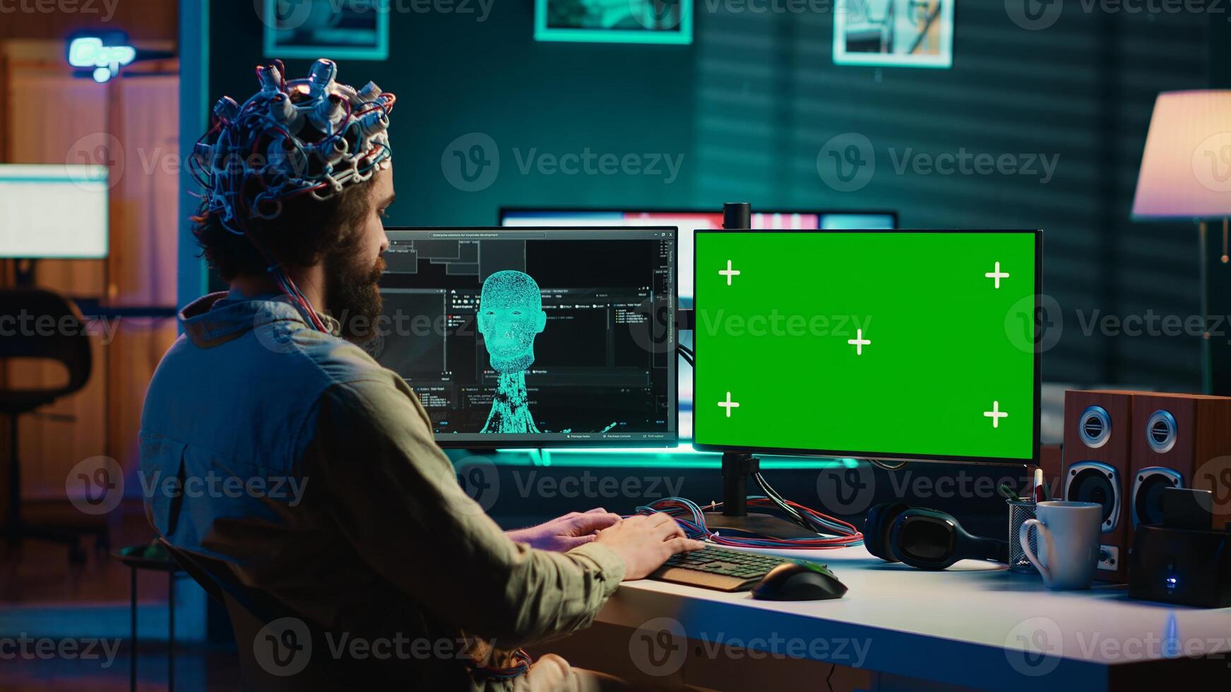IT admin coding and using EEG headset to upload brain into mockup computer, gaining immortality. Neuroscientist engineering transhumanism experiment on isolated screen PC, camera A photo