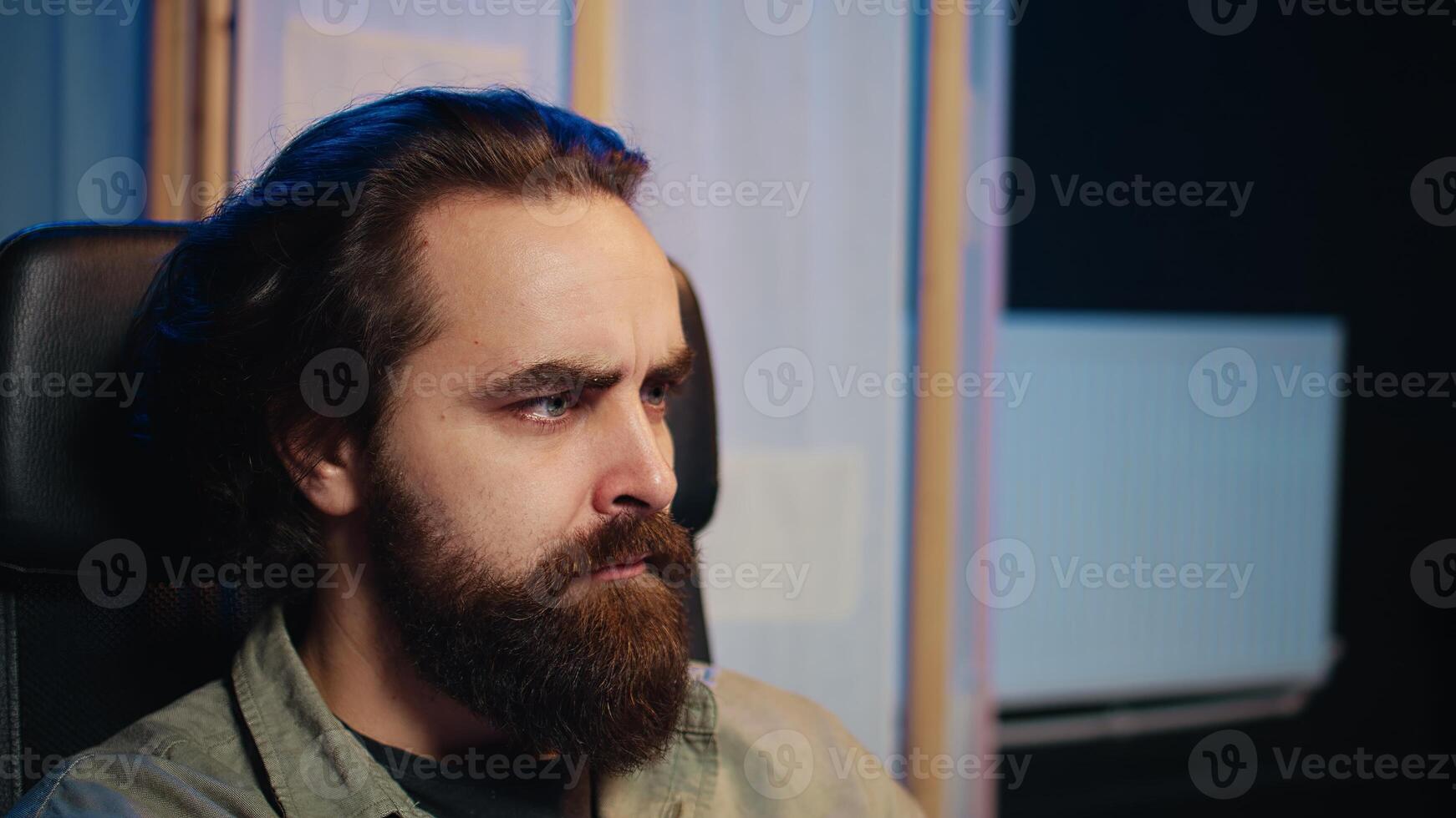 Man getting scared while programming after AI becomes sentient, afraid of it spiraling out of control and dooming humanity. Developer worried by conscious artificial intelligence, camera B close up photo