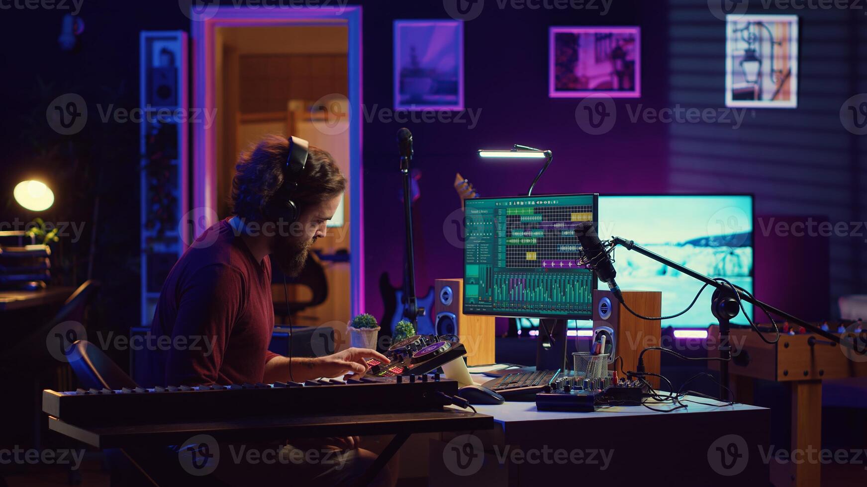 Joyful artist playing piano keyboard and recording tunes for mixing and mastering session, enjoying midi controller performance in home studio. Energetic music producer creating soundtracks. Camera A. photo